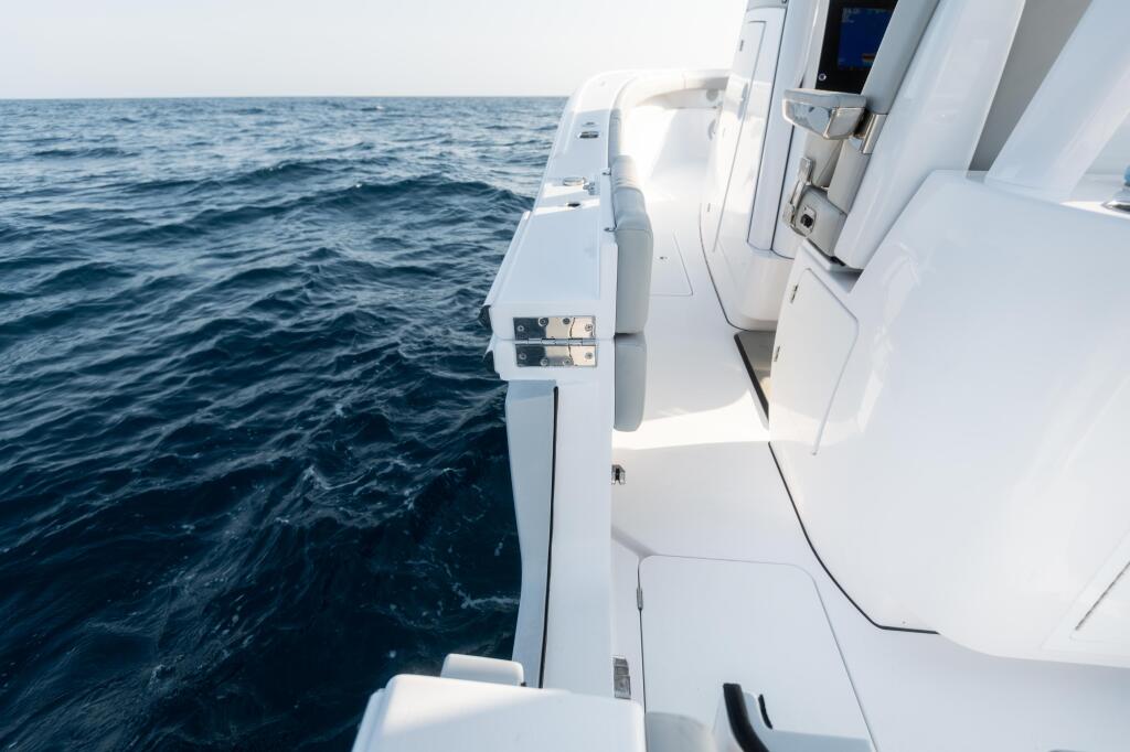White boat gunwale and cabin door overlooking calm offshore waters