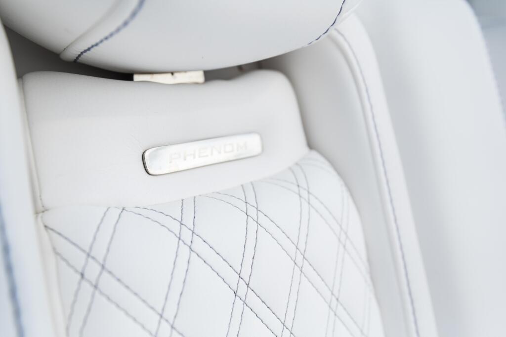 White quilted boat seat with embroidered nameplate detail and contrasting blue stitching