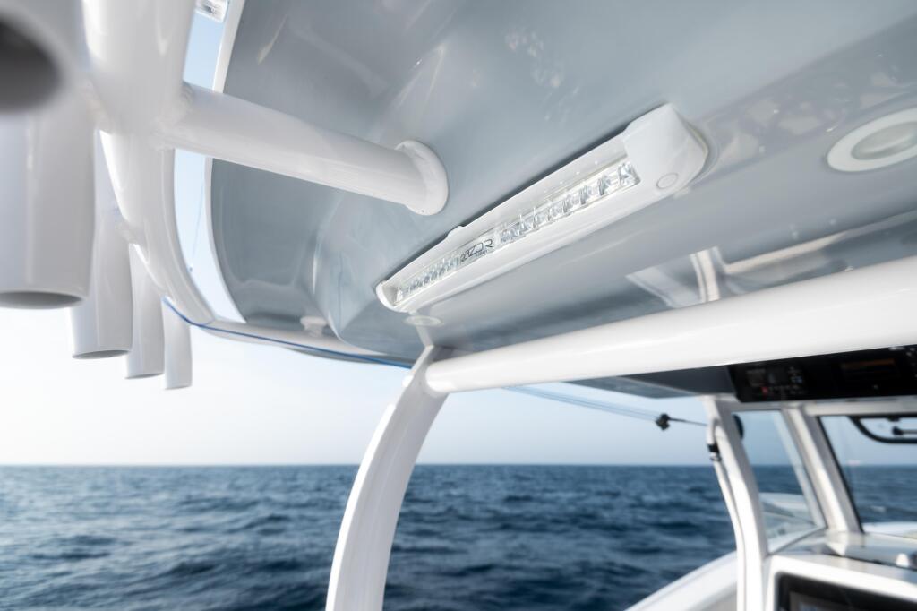 LED spreader lights mounted on the hard-top interior with open ocean visible in the background