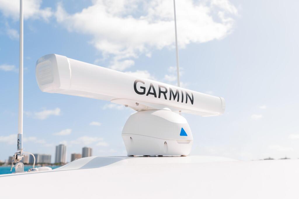 Garmin Fantom 124 radar dome mounted on boat helm with cityscape and blue sky in background