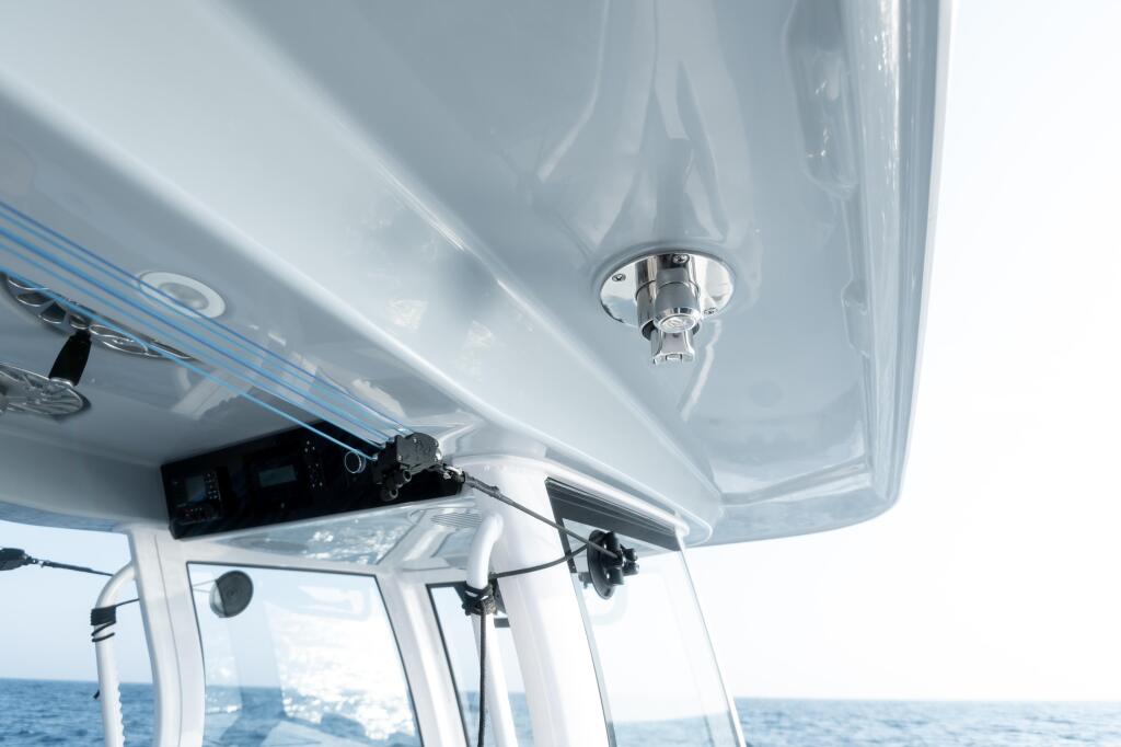 Hard-top grab rail detail showing chrome fixture and windshield with ocean view