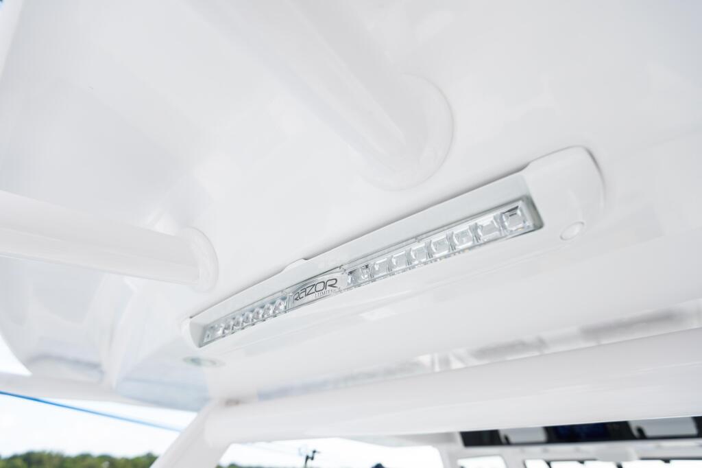 LED spreader light mounted on boat hardtop with chrome trim and integrated controls