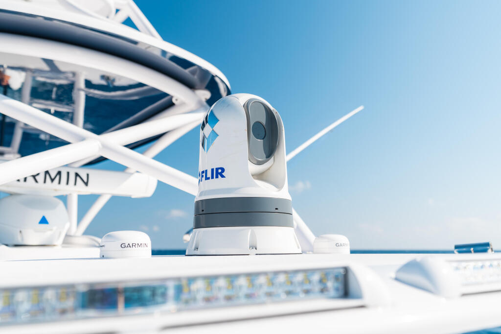 FLIR thermal camera mounted on boat helm with Garmin electronics and hard-top canopy visible