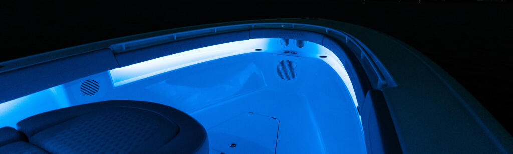 LED lighting strips glowing blue inside boat cabin with speaker grilles visible