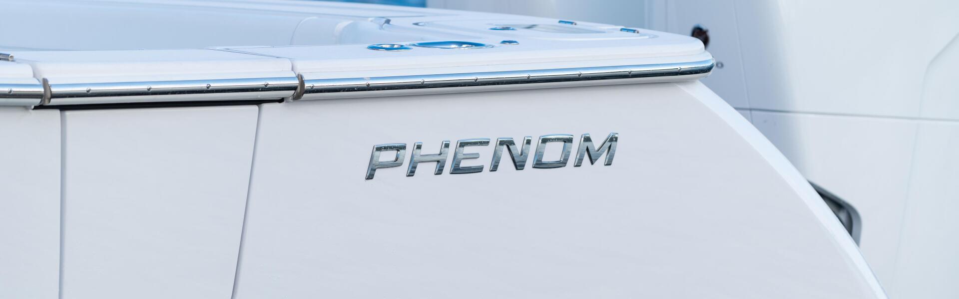 Phenom 37 boat running offshore with Mercury engines visible in the background