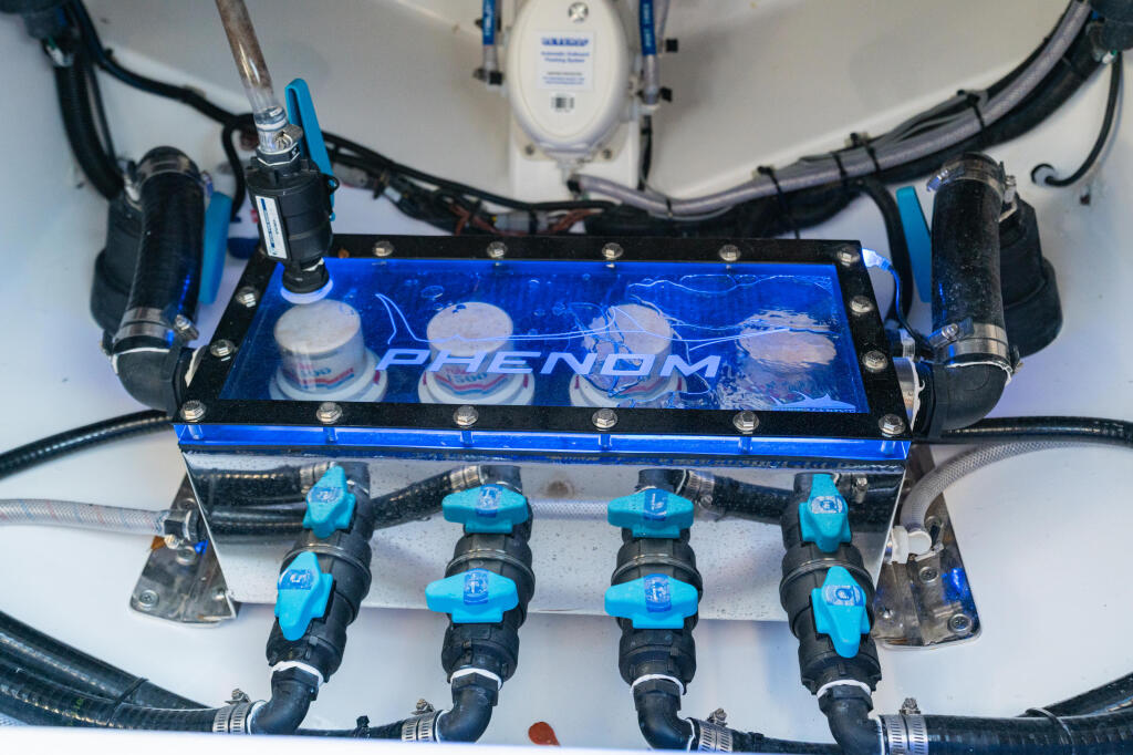 Marine life support system with blue valve manifold, circulation pumps, and plumbing connected to tank components