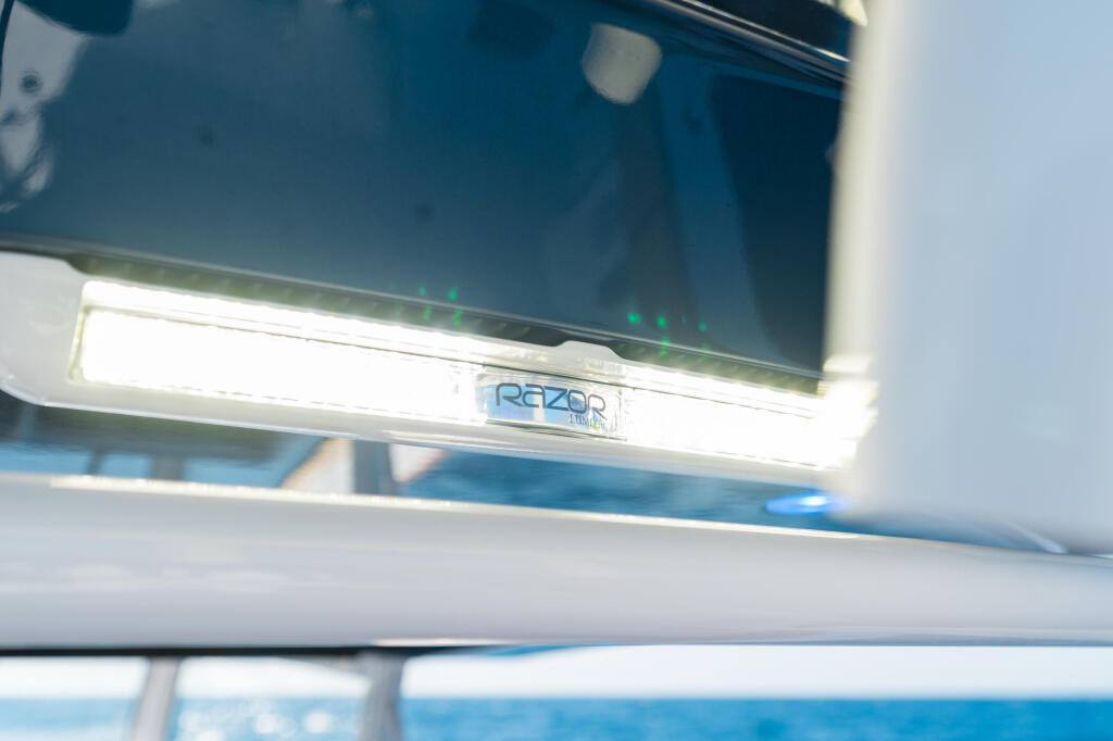 Razor brand LED spreader lights mounted on boat hardtop with white illumination and green indicator lights