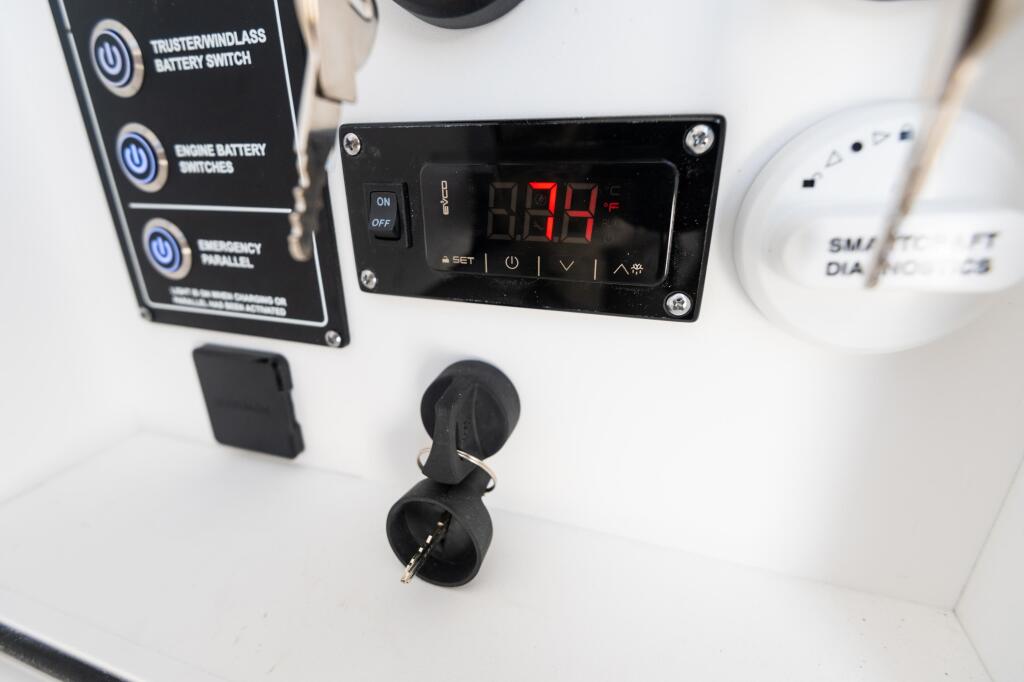 12-volt air conditioning control panel and battery switches mounted on boat console
