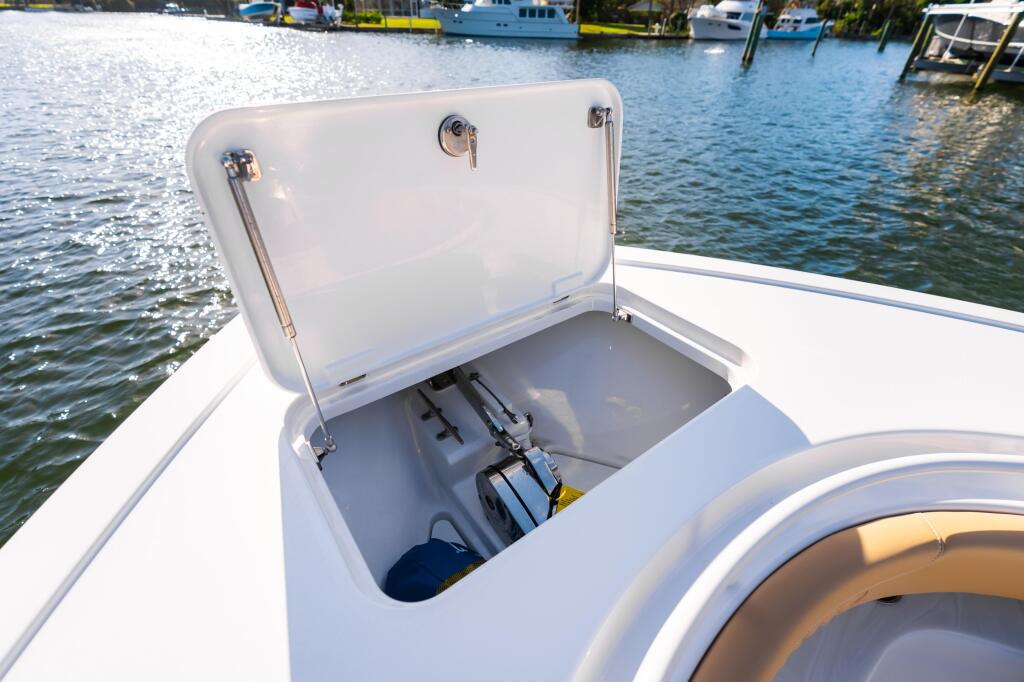 Open livewell storage compartment on boat deck with fishing equipment and tackle storage visible inside