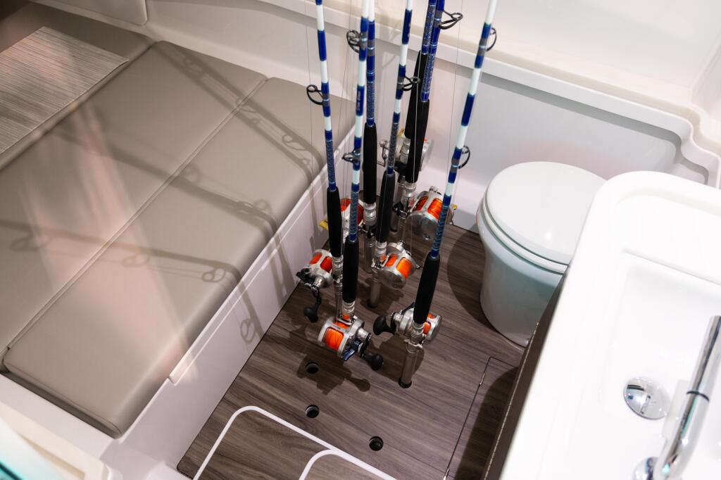 Fishing rod storage system with multiple rods mounted in cabin near head and berth