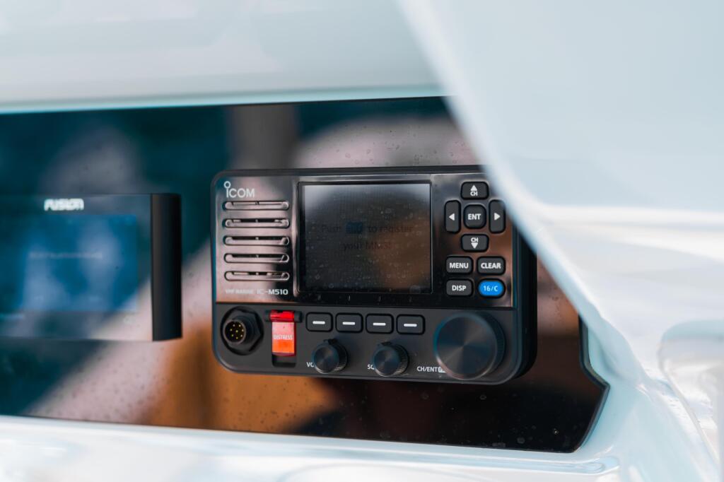 Icom M510 VHF marine radio mounted on a boat's helm console with display screen and control buttons visible