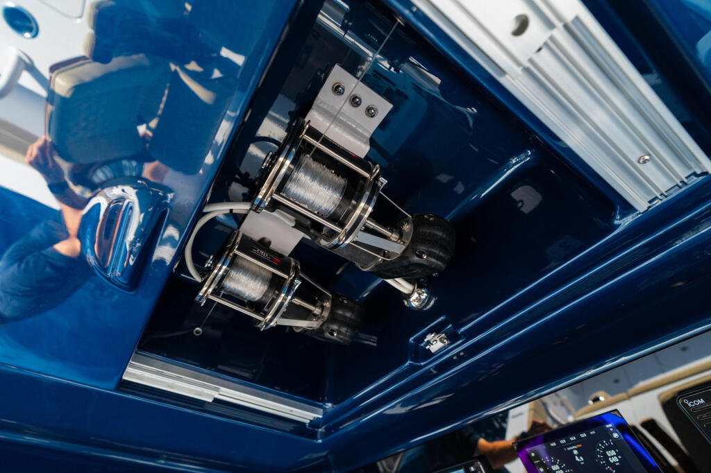 Dual electric fishing reels mounted under the hard-top with control panel visible below