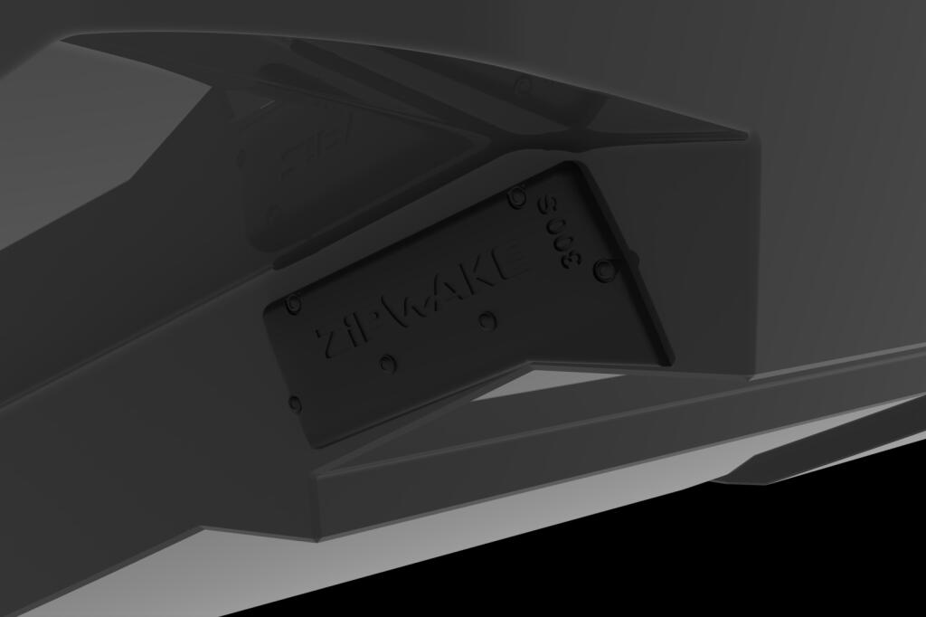 Close-up of a Zipwake dynamic trim control system component mounted on boat hull