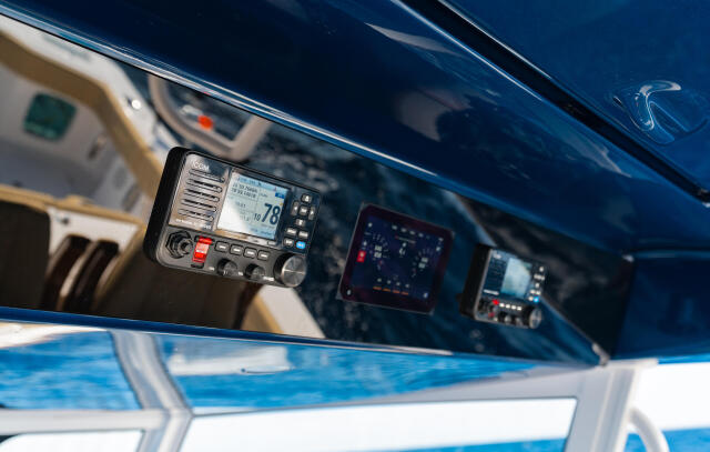Marine VHF radio mounted in boat helm with navigation and communication electronics visible