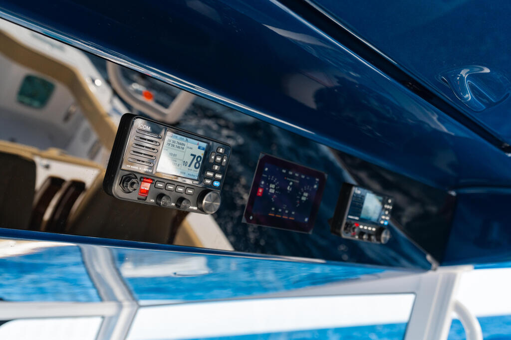 Marine VHF radio mounted in boat helm with navigation and communication electronics visible