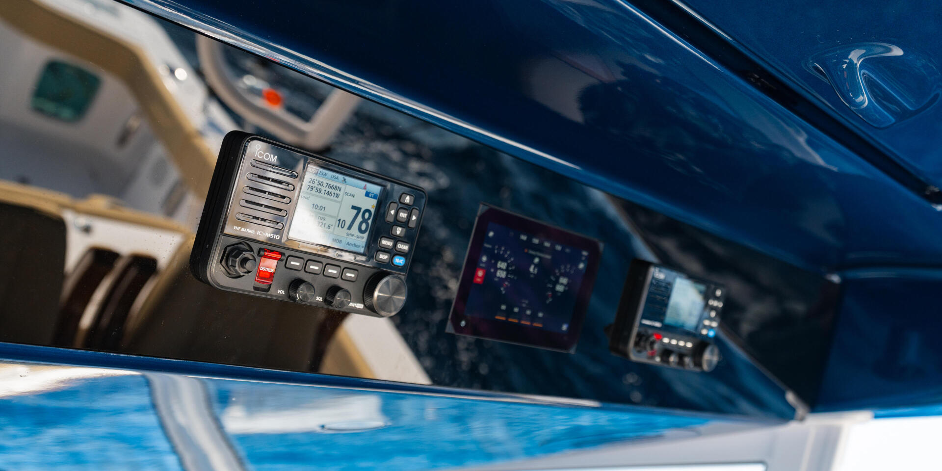 Marine VHF radio mounted in boat helm with navigation and communication electronics visible