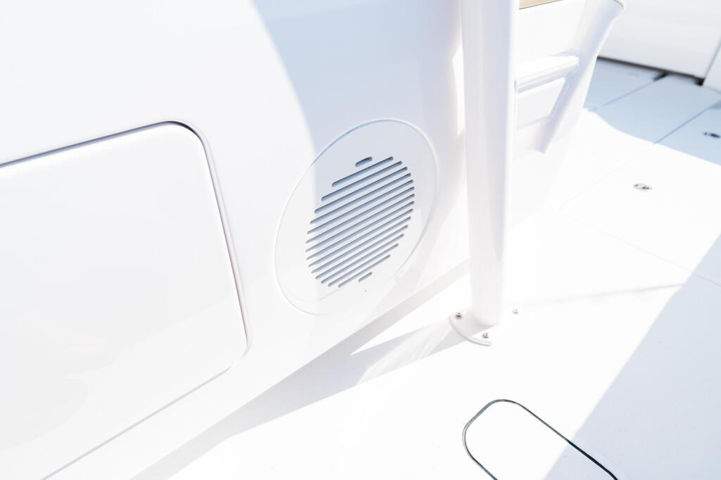 White boat cabin detail showing ventilation speaker grille and hardware
