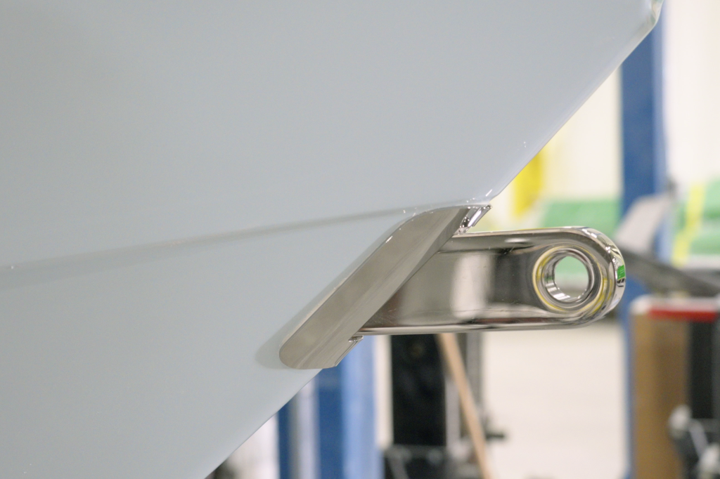 Close-up of a polished stainless steel towing eye mounted on a boat's hull