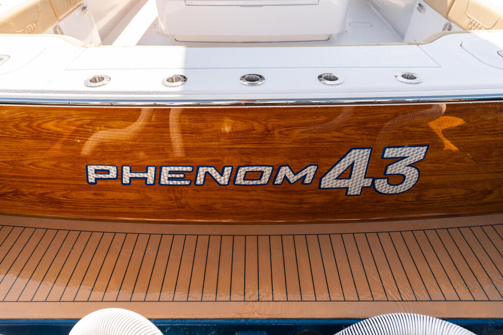 Phenom 45 boat name with teak-style wood transom and recessed lighting detail