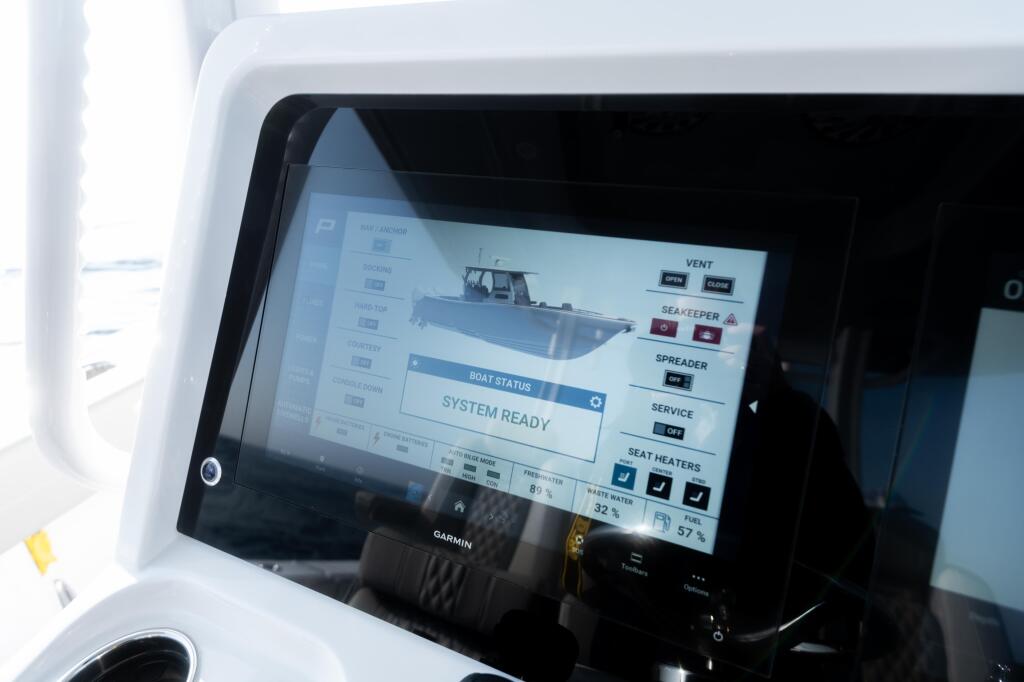 Garmin touchscreen display showing boat status systems ready with various controls and indicators at the helm