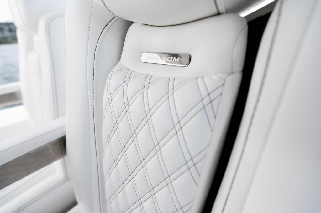 White leather helm seat with quilted diamond pattern and Phantom nameplate badge