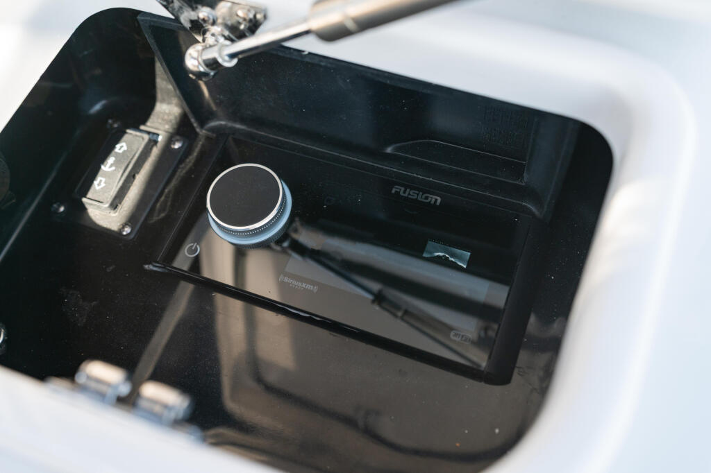 Fusion Apollo marine audio system with rotary volume control mounted on boat dashboard