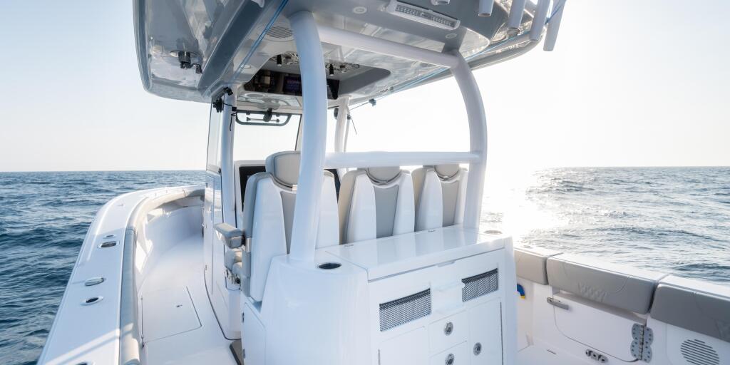 Center console boat helm with hard-top, leaning post seating, and electronics overlooking open ocean