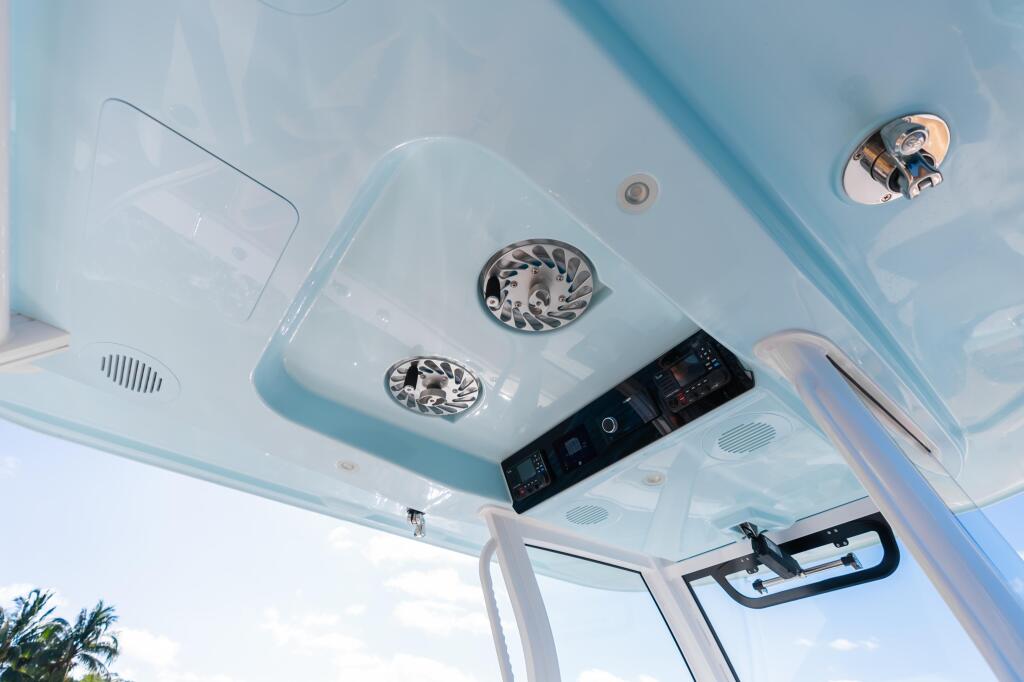 Cabin ceiling with dual vent fans, control panel, recessed lighting, and chrome fixtures