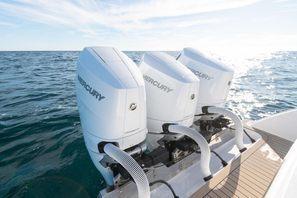 Three Mercury Verado engines mounted on the transom of a boat in open water